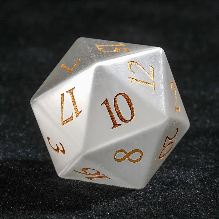 Close-up of a White Jade Pirate D10 die, artisan-crafted with golden numerals, showcasing intricate pirate motifs.