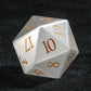 Close-up of a White Jade Pirate D10 die, artisan-crafted with golden numerals, showcasing intricate pirate motifs.