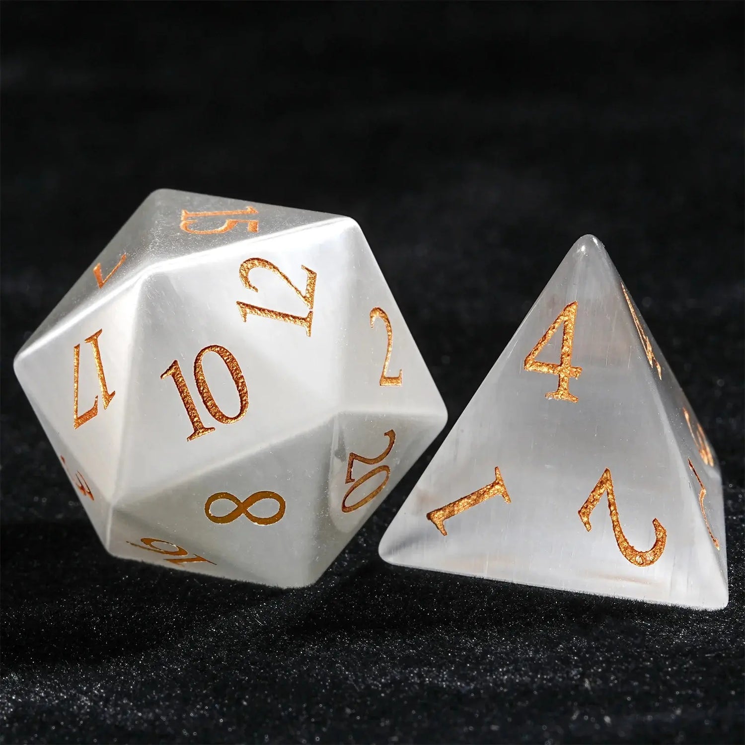 White Jade Pirate Dice Set featuring intricately crafted D10 and D4 with golden numerals on a black background.