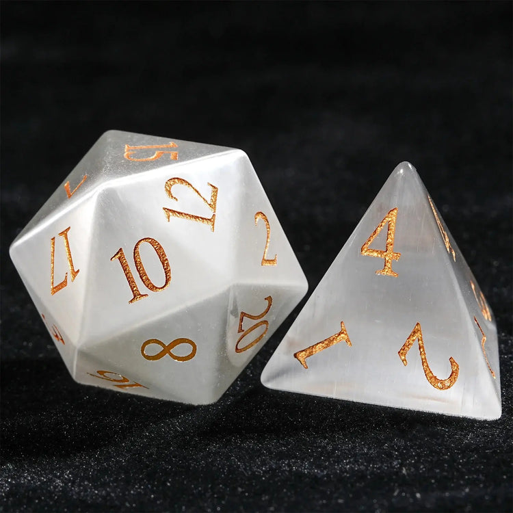 White Jade Pirate Dice Set featuring intricately crafted D10 and D4 with golden numerals on a black background.