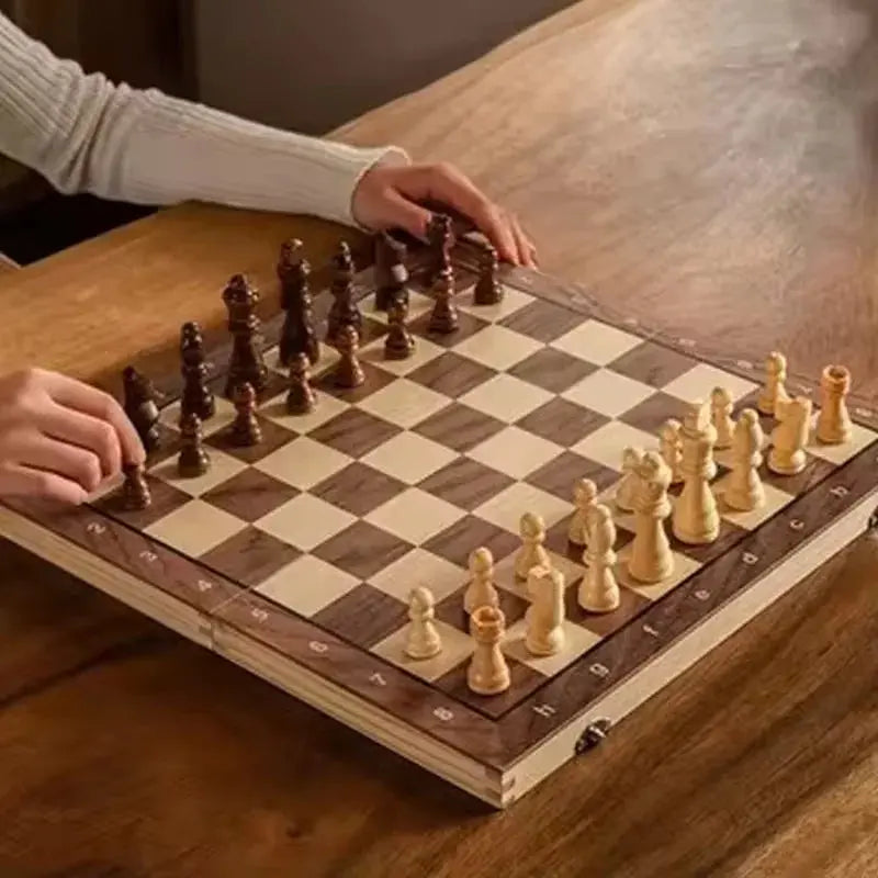 Person playing on a foldable travel chess set with wooden pieces on a stylish board.